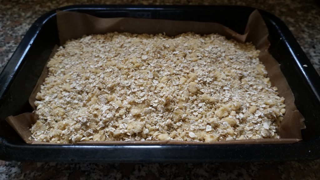 Date and oat slices ready to be baked