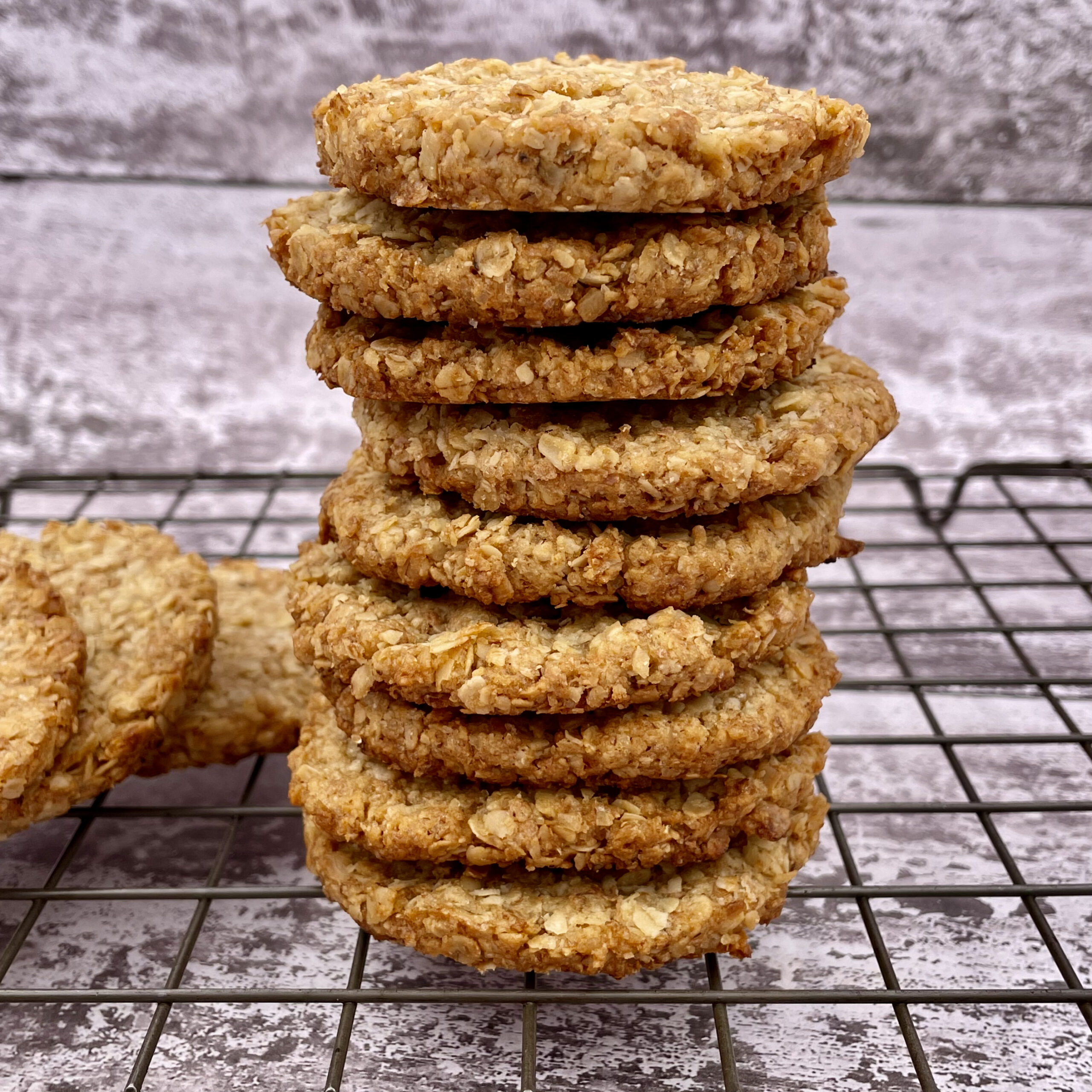 A stack of homemade oat biscuits on a wire rack
