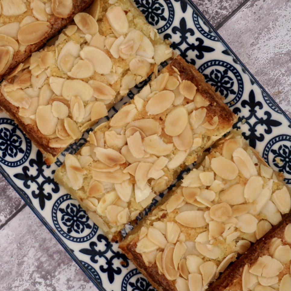 Individual frangipane slices on a serving plate