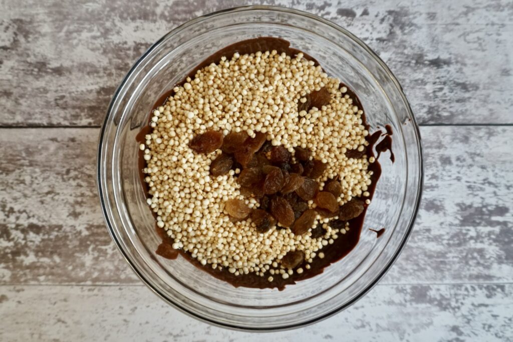 Bowl of chocolate, puffed quinoa and raisins