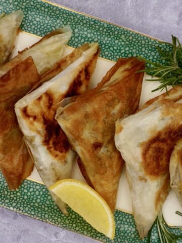 A plate of vegetable samosas with filo pastry.