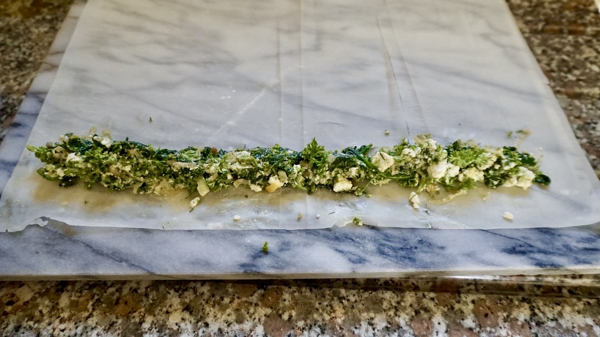 spinach and feta filling on a sheet of filo pastry