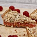 A slice of fruit tart with crumble topping.