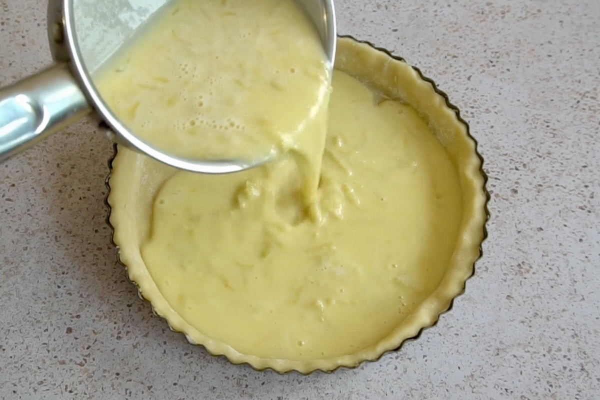 Pouring the lemon custard into a pastry case