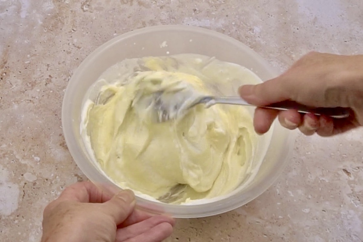 Folding the melted chocolate into the whipped cream