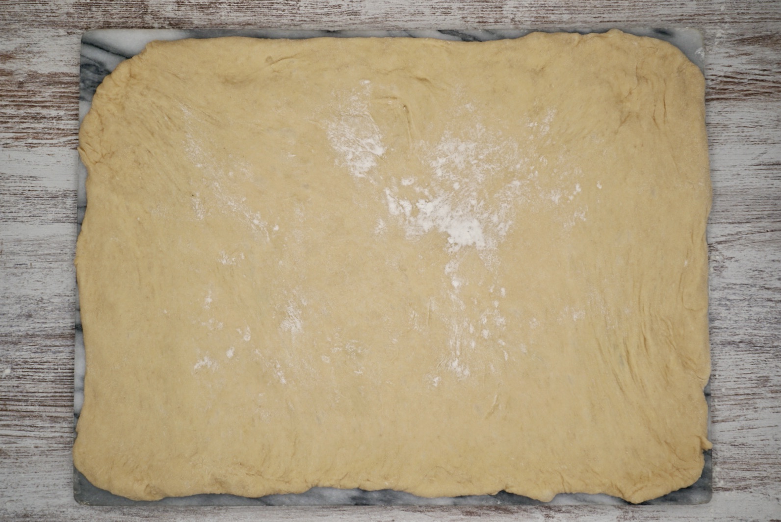 A rectangle of bread dough on a board