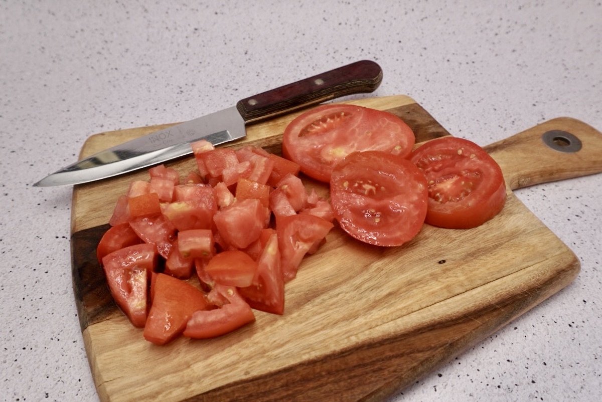 Chopped tomatoes on a board.
