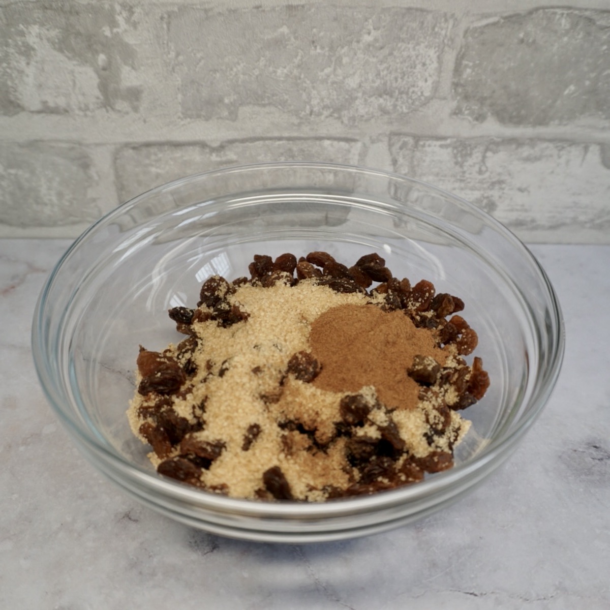 A bowl with raisins, brown sugar and cinnamon