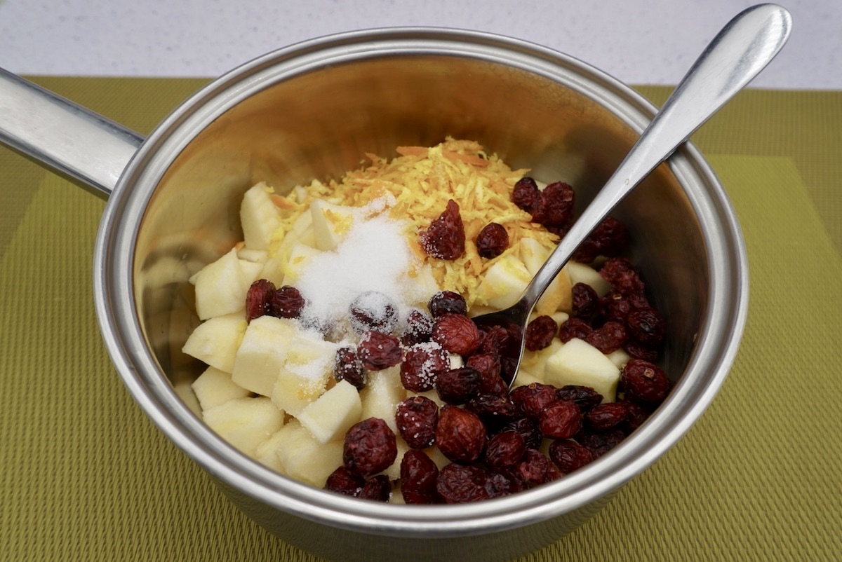 Chopped apples, cranberries and orange zest in a pan