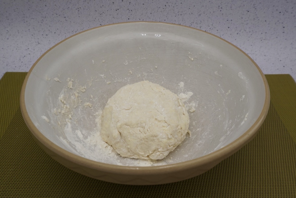 A ball of pastry dough in a bowl