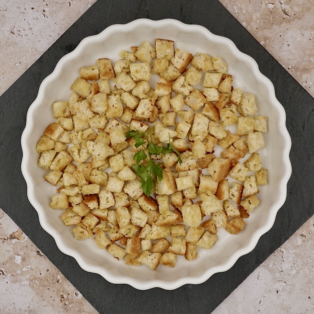 Overhead view of a bowl of homemade croutons.