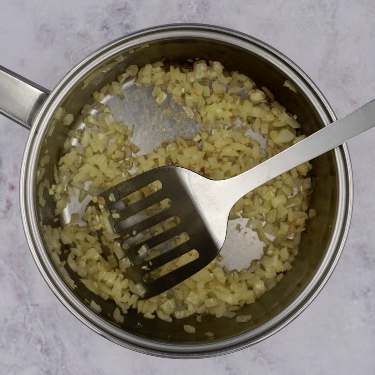 Cooking onion and garlic in a pan