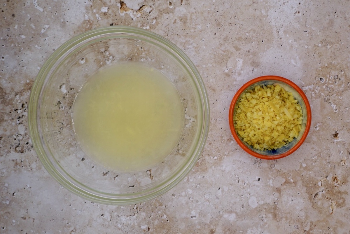 A bowl of lemon juice and a bowl of lemon zest