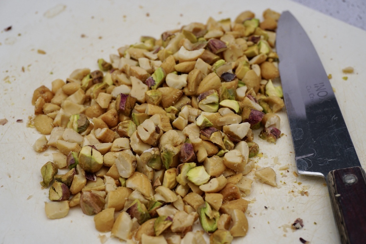 Chopped nuts on a board with a knife