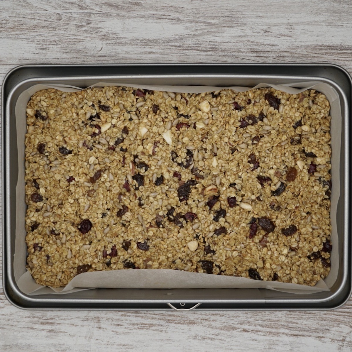 Fruit and nut flapjack in a baking tin.