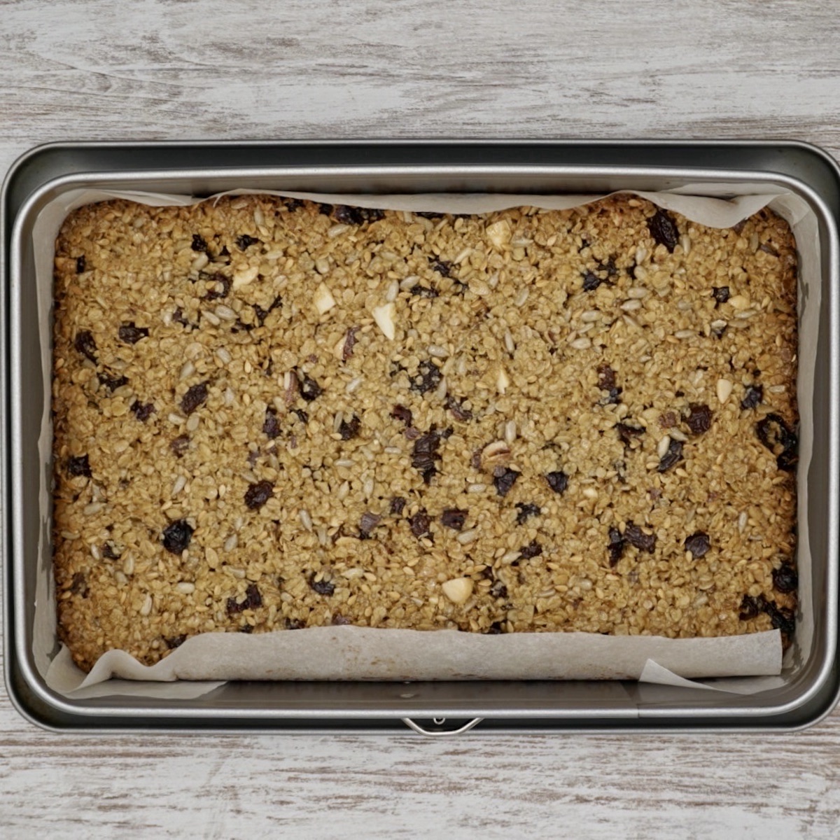 Fruit and nut flapjack in a baking tin.