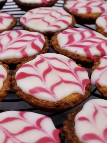 Several iced Bakewell tarts.