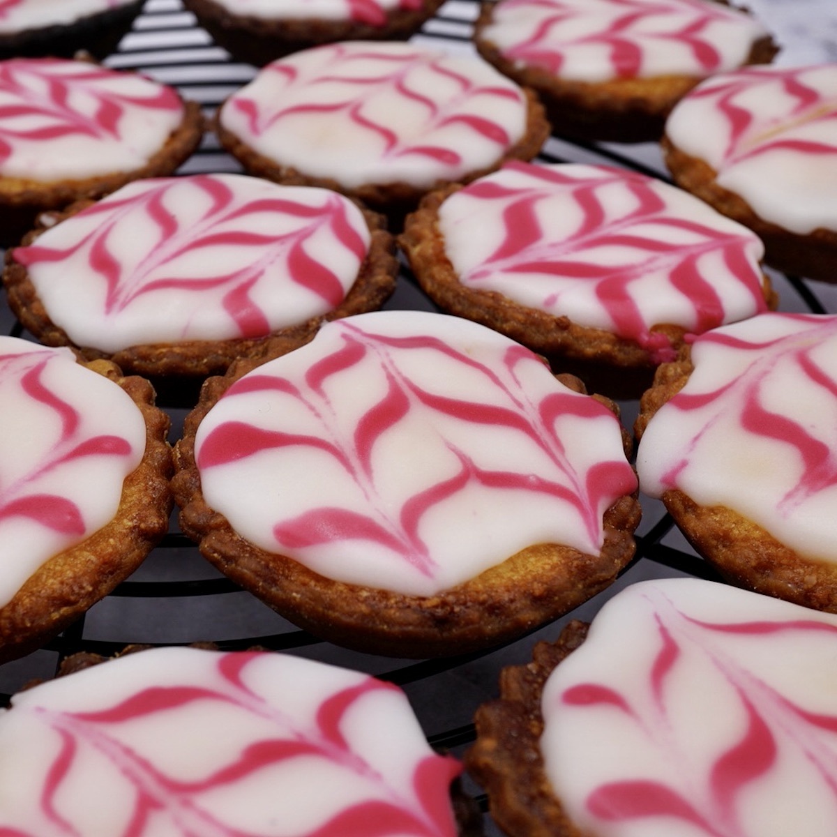 A group of iced Bakewell tarts.