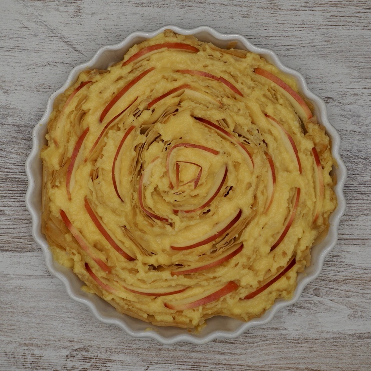 An unbaked apple custard tart made with filo pastry.