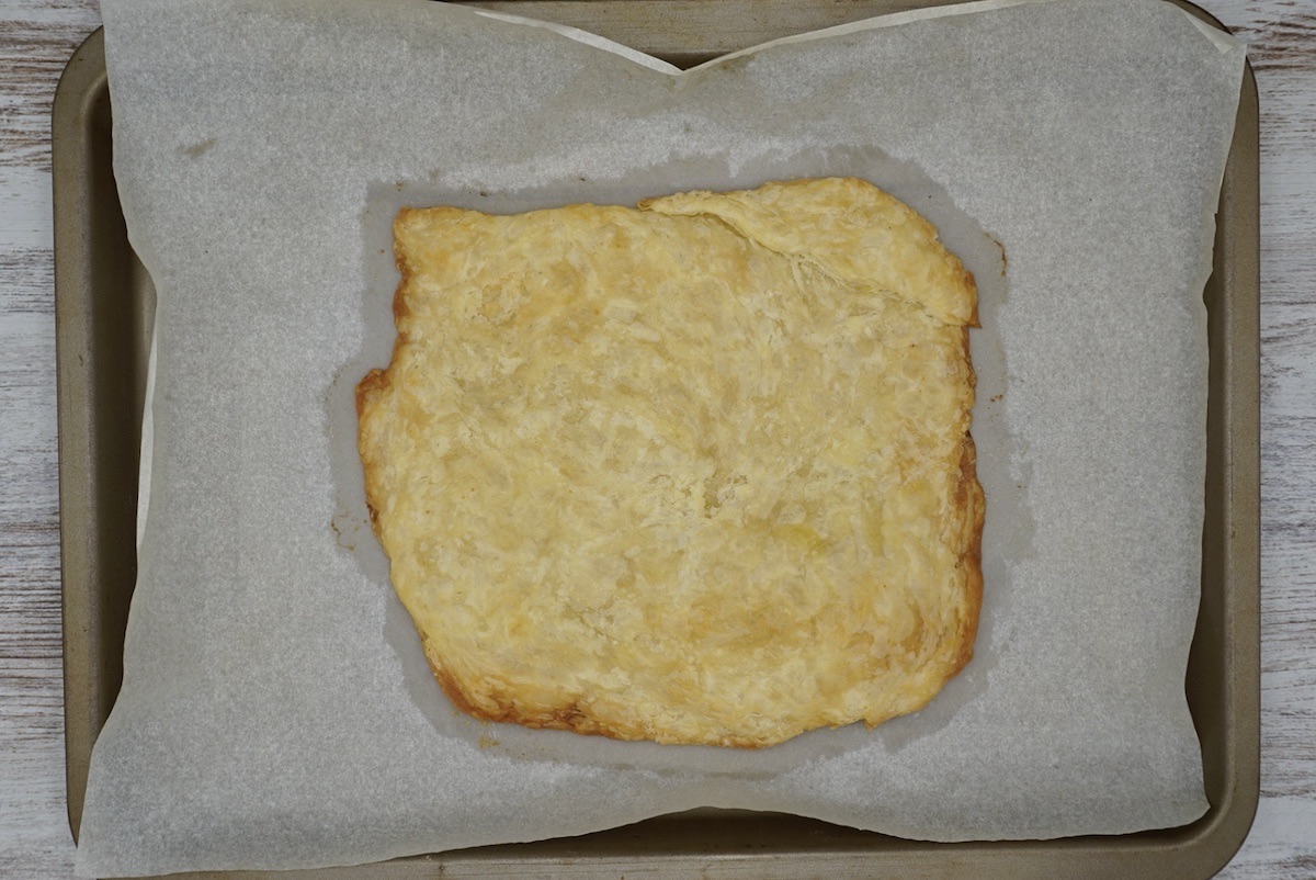 A cooked sheet of pastry on a baking tray.