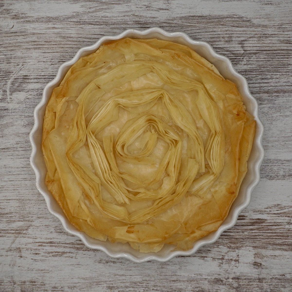 Baked filo pastry in the form of circles in a tart dish.