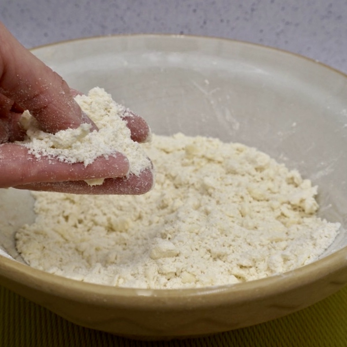 Preparing crumble topping mix by hand.