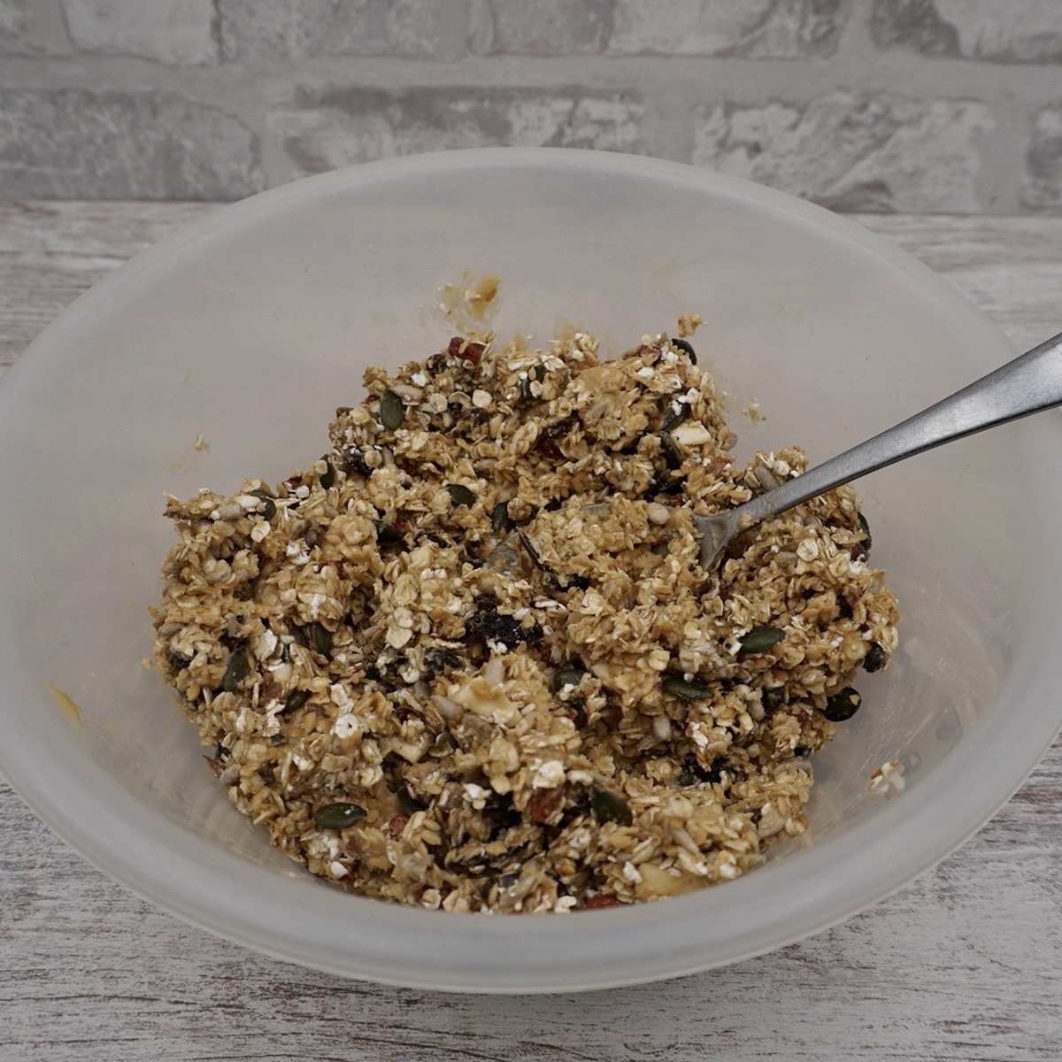 A bowl containing granola ingredients.