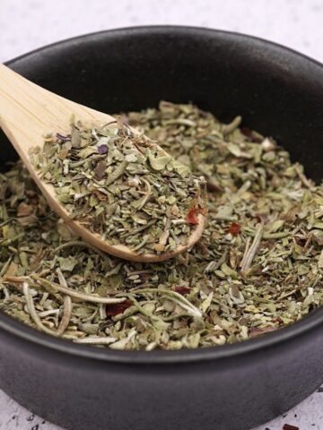 Homemade seasoning blend in a small bowl with spoon.