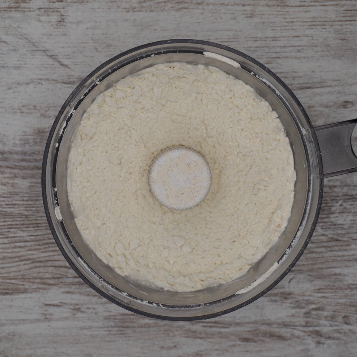 Pulsed flour and butter in a food processor bowl.