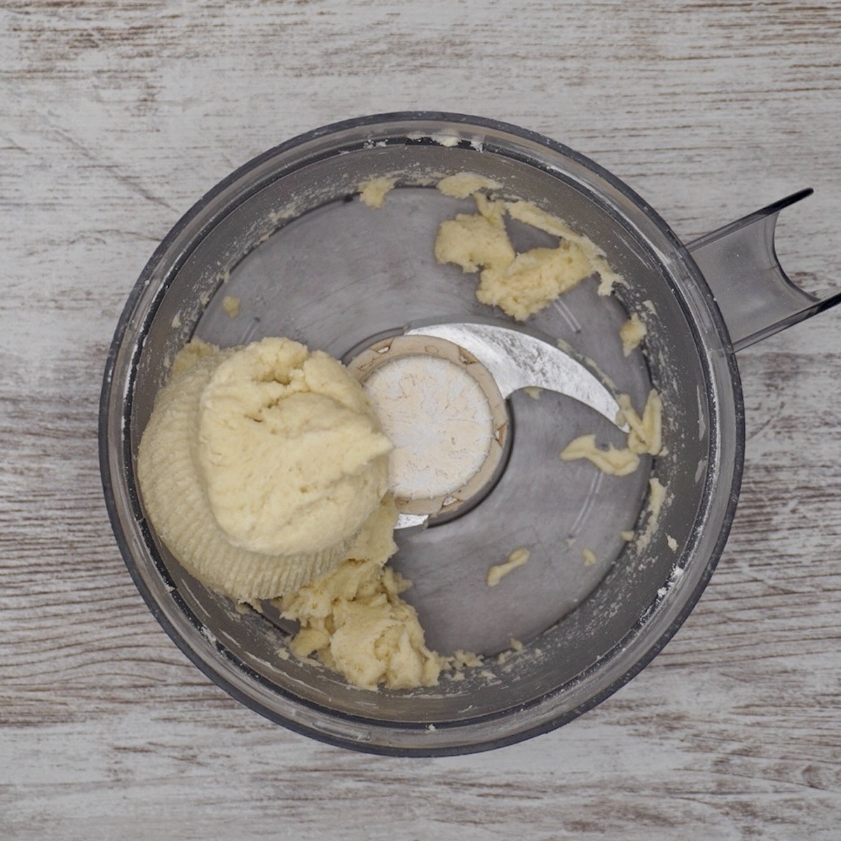 Pastry dough in a food processor bowl.