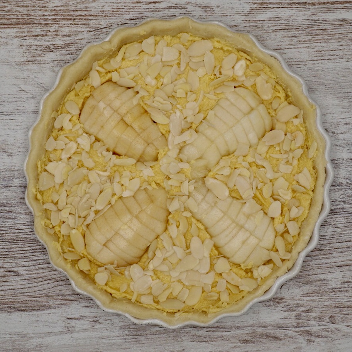 An unbaked pear and almond tart.