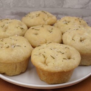 Several individual focaccia rolls on a plate.