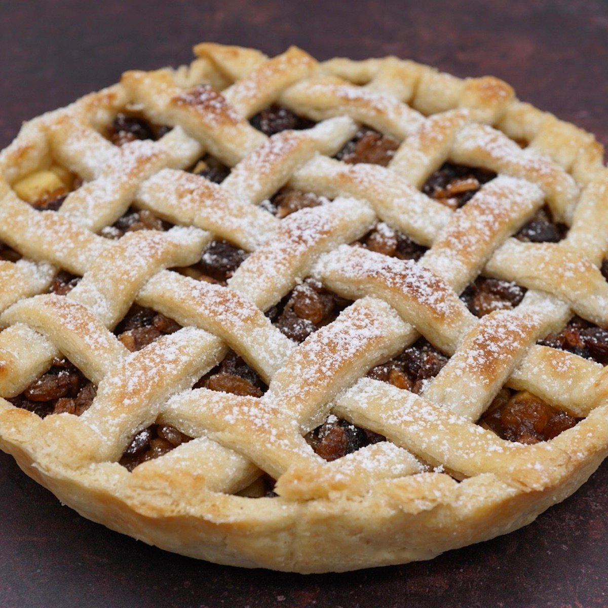 A lattice topped tart with apple and mincemeat.