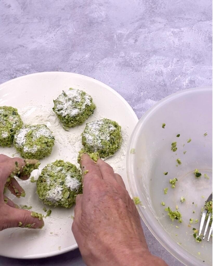 Edamame fritters being formed into shapes by hand.