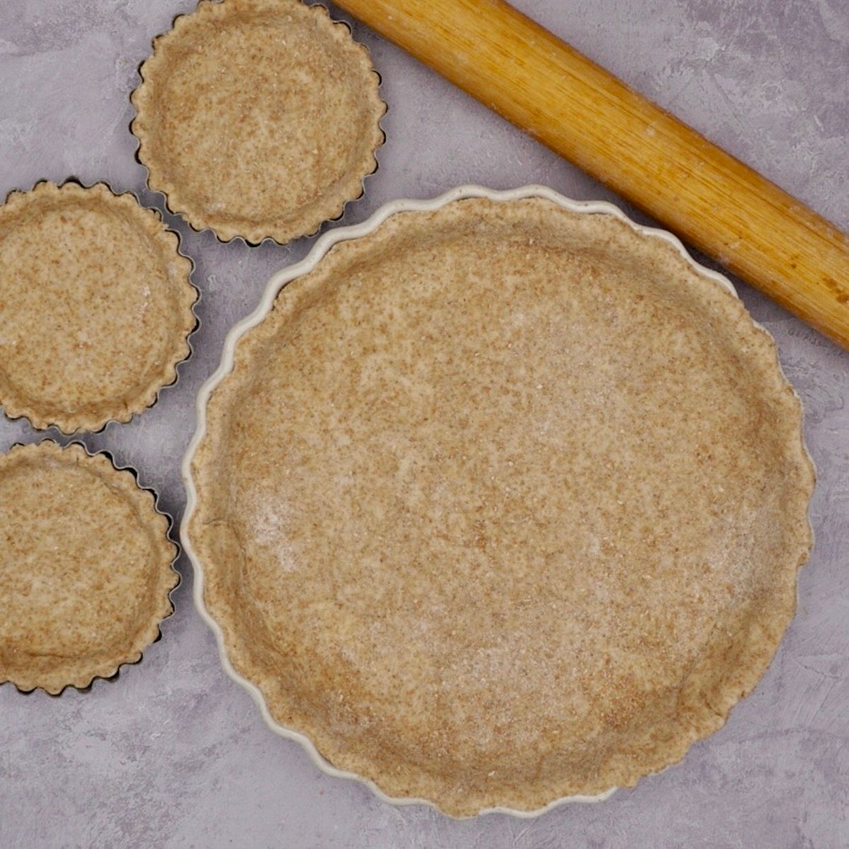 Tart dishes lined with wholemeal pastry.