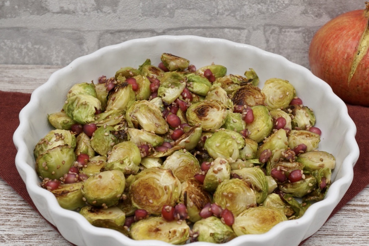 A bowl of roast sprouts with pomegranate.