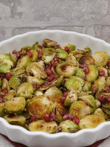 A bowl of roast sprouts with pomegranate.