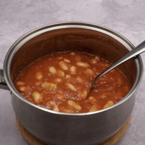 A pan of homemade baked beans in tomato sauce.