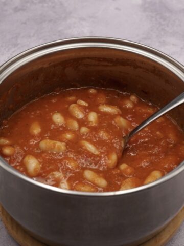 A pan of homemade baked beans in tomato sauce.
