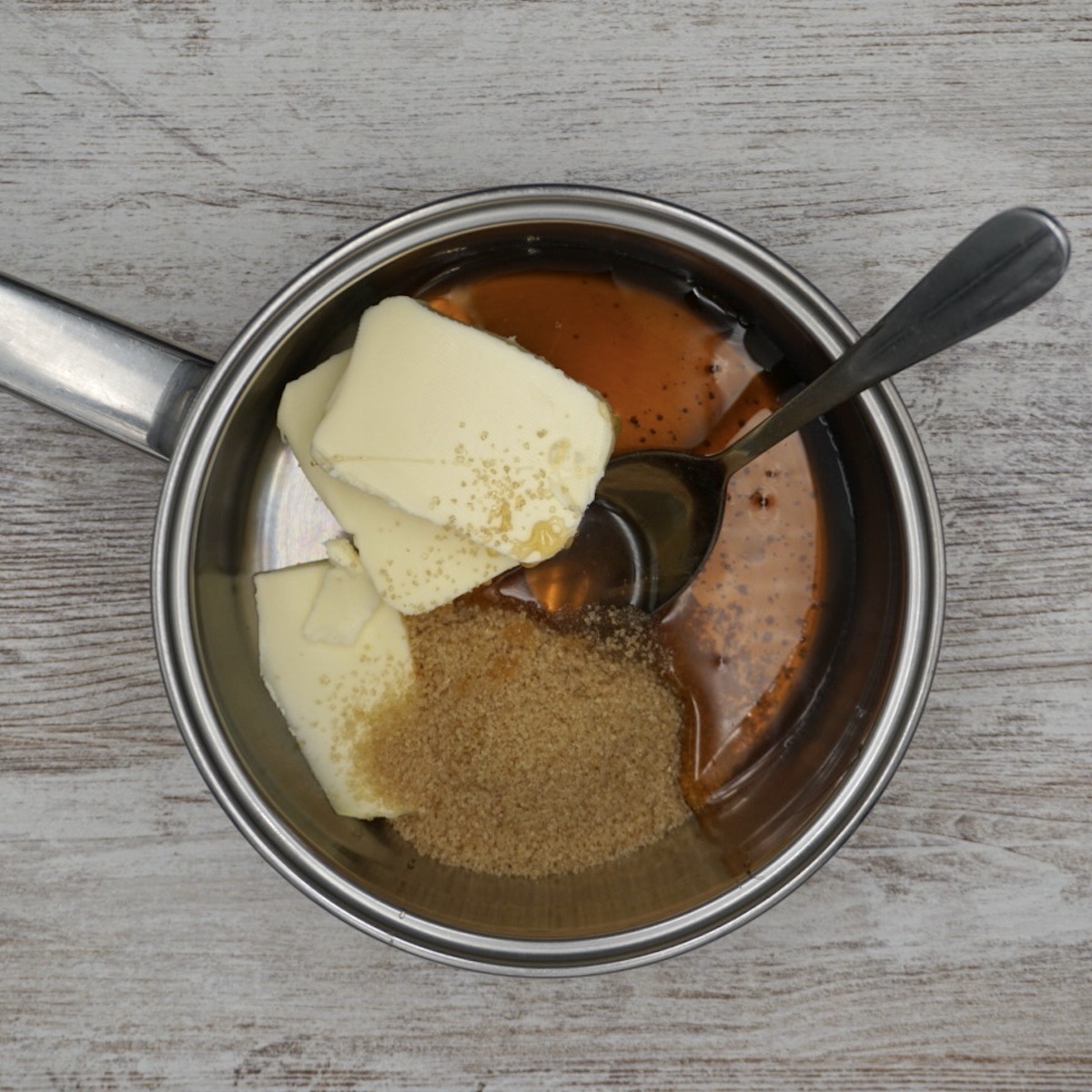 A pan containing butter, sugar and honey.