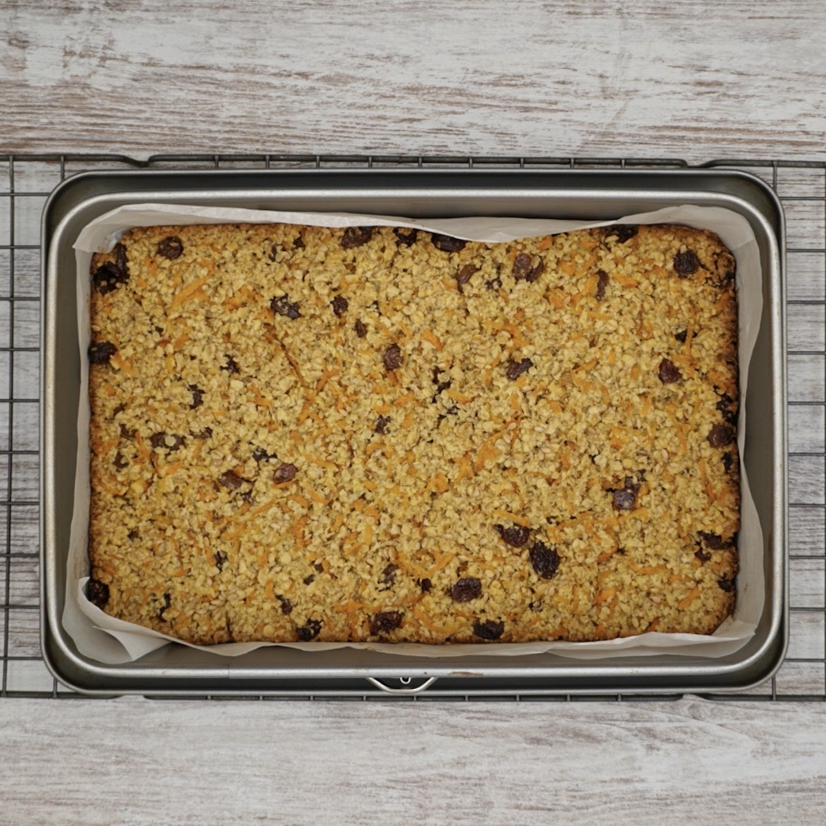 Oat and carrot flapjacks in a baking tin.