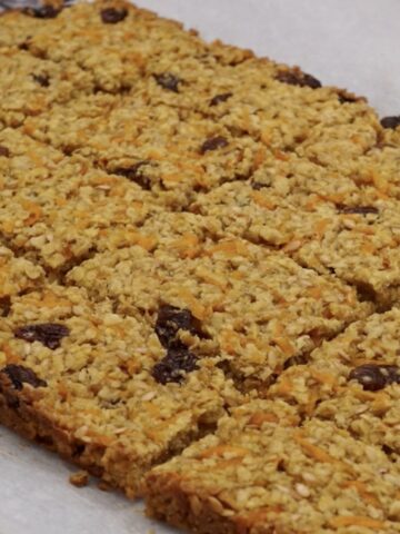 Carrot flapjack cut into portions.
