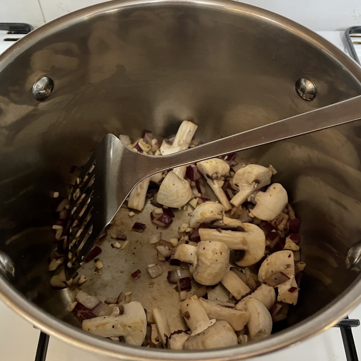Mushrooms, onions and garlic in a pan.