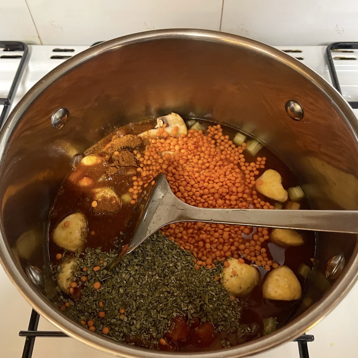 Lentil ragout ingredients in a pan.