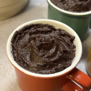 An espresso cup containing avocado chocolate mousse.