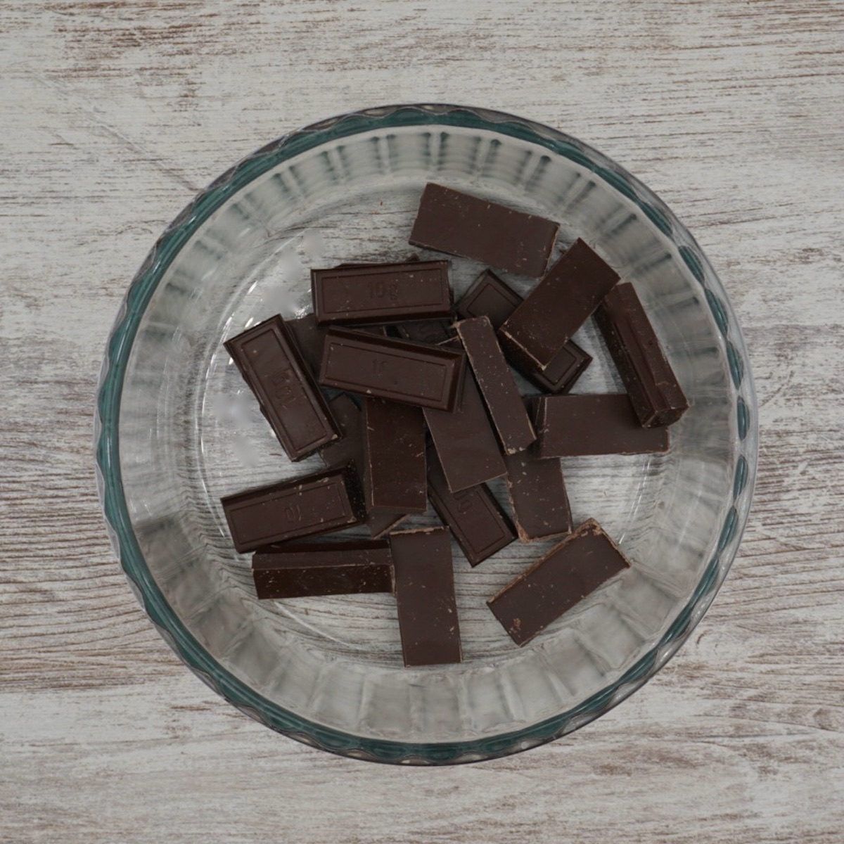 Pieces of chocolate in a glass bowl.