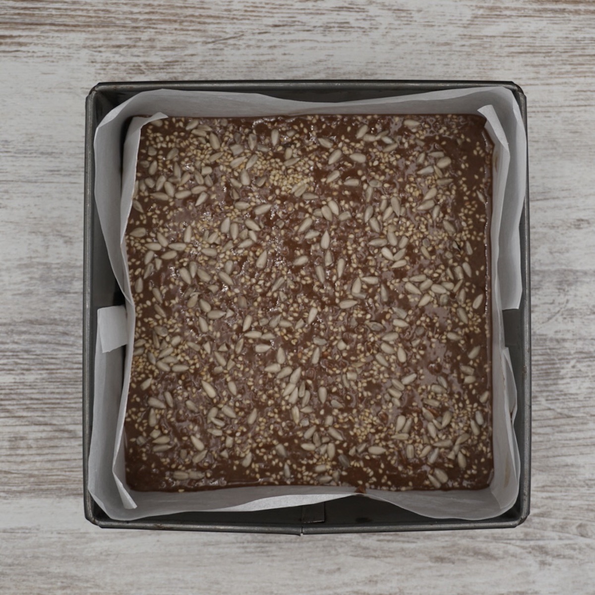 Chocolate tahini in a lined cake tin.