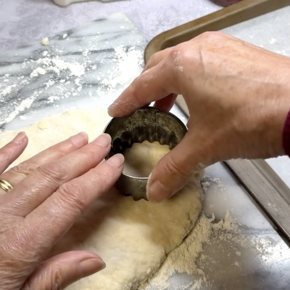 Cutting a scone out of dough. 