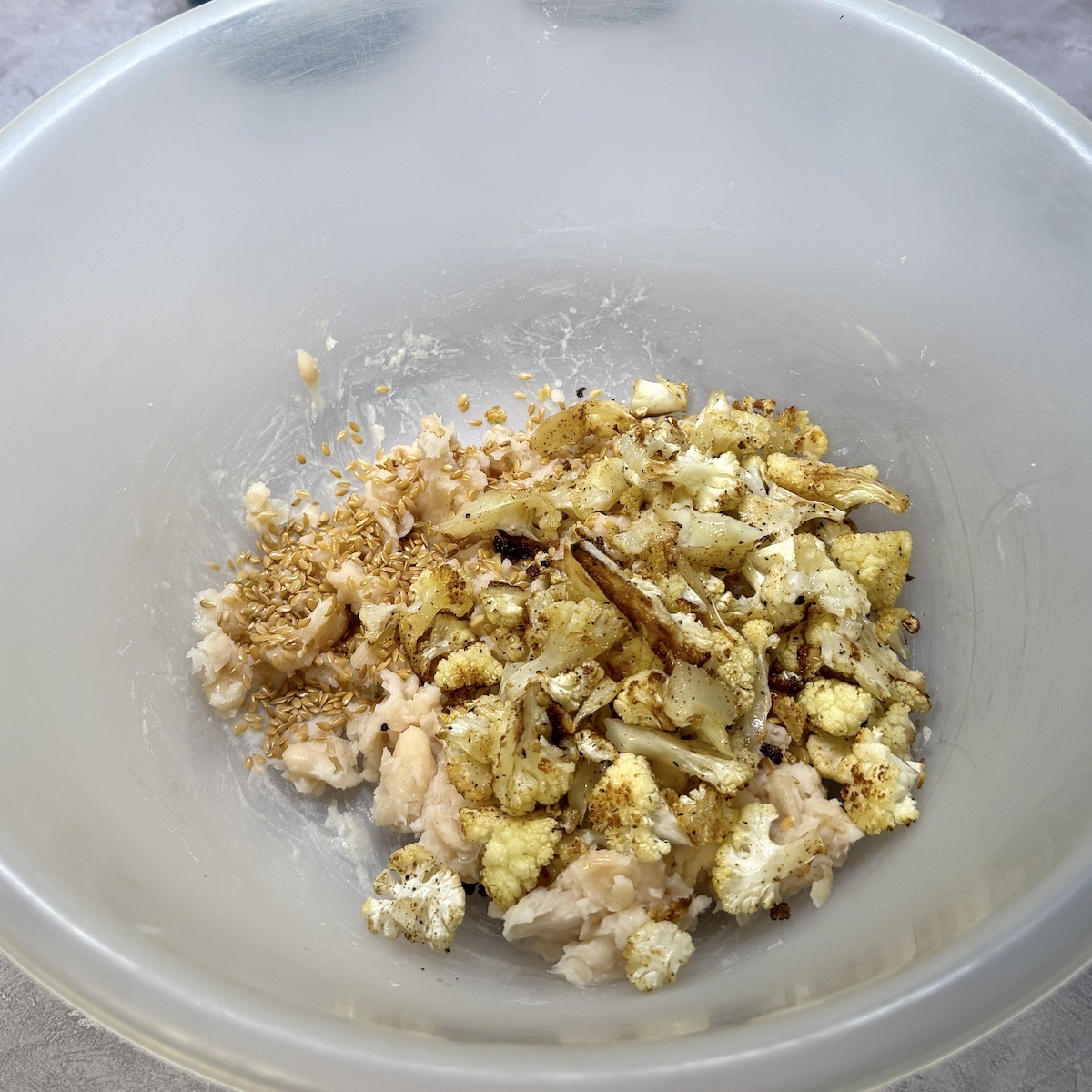 Cauliflower cake ingredients in a bowl.