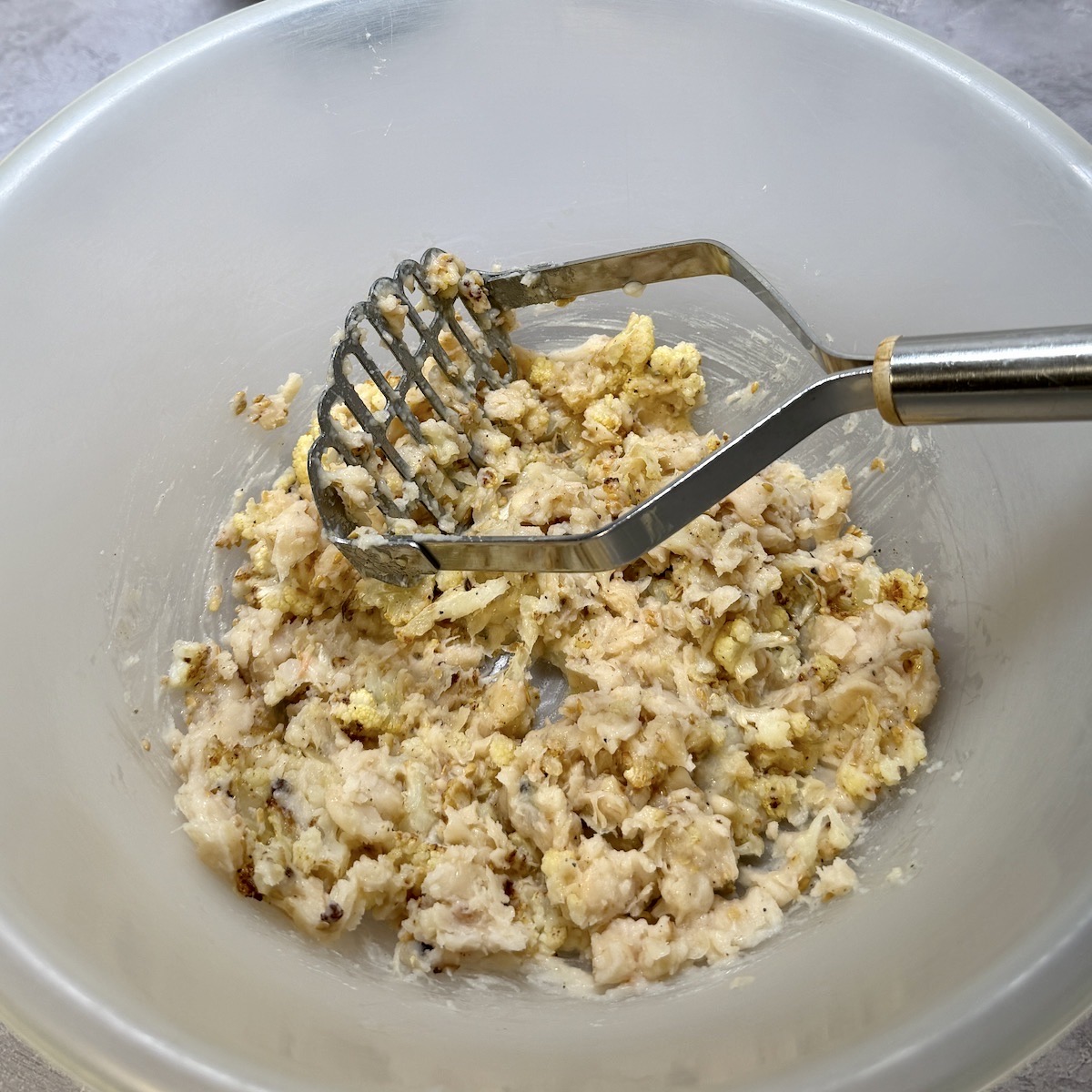 Cauliflower cake ingredients in a bowl.
